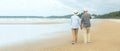 Asian Lifestyle senior couple walking chill on the beach happy in love romantic and relax time after retirement. Royalty Free Stock Photo